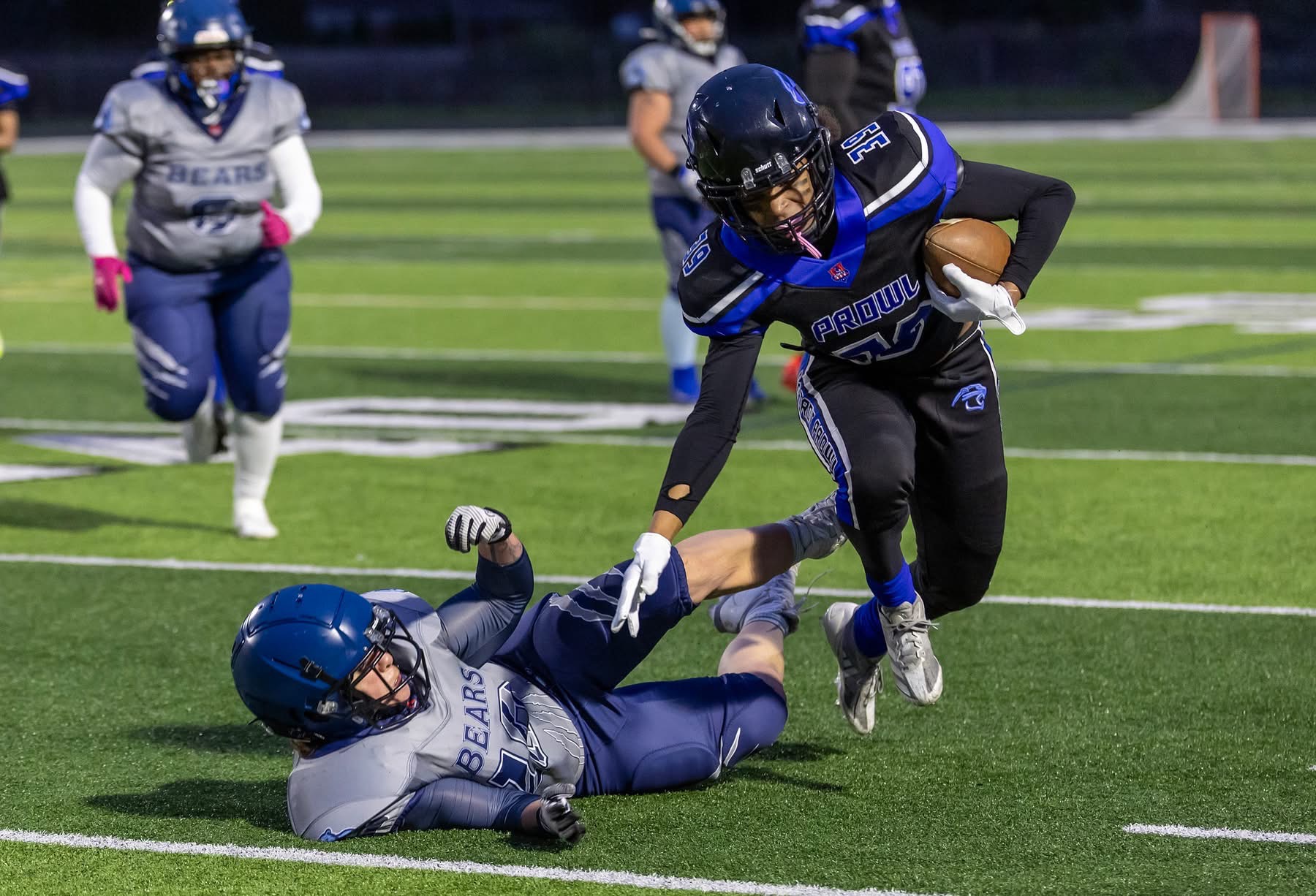 Detroit Prowl player carrying the ball past a defender